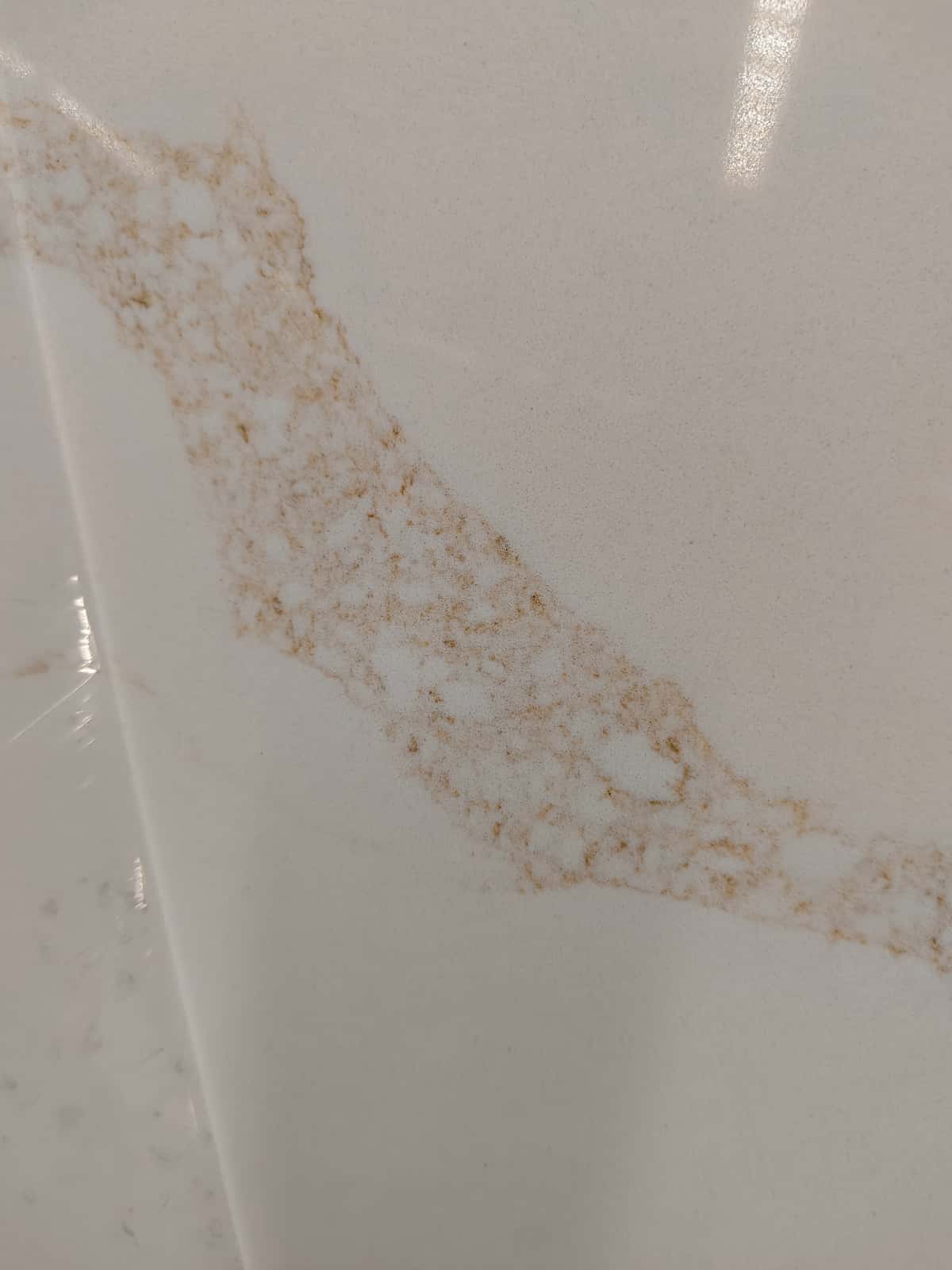 Large-format quartz slab creates a bright and refined kitchen interior