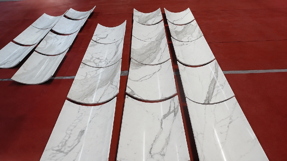 Close-up of Calacatta White marble panel edges and polished surface, showing uniform texture and quality control checks