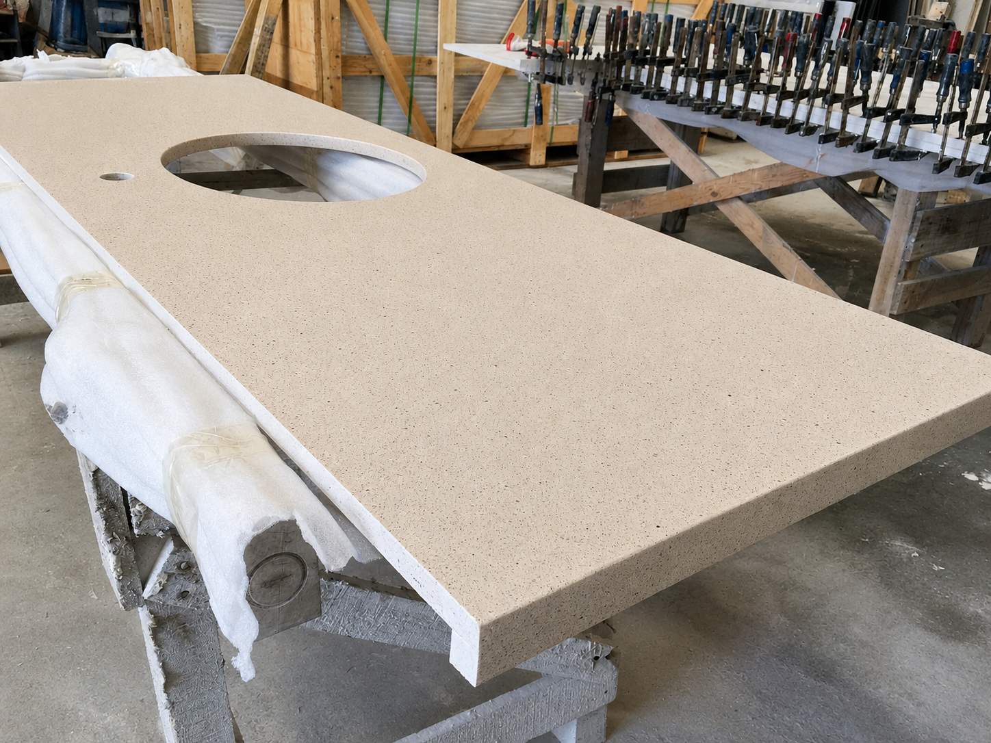 Warm beige quartz countertop with fine speckled texture and polished finish for multifamily bathroom vanity use 