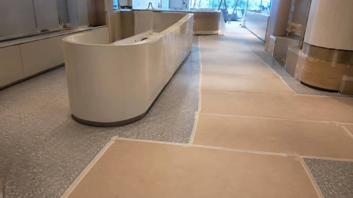 Terrazzo floor protected during interior project finishing work before handover