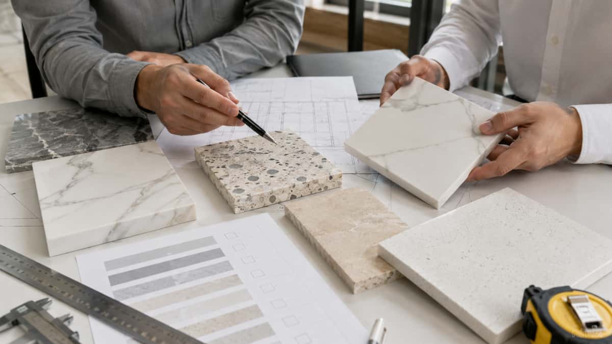 Project buyer reviewing stone samples drawings and material options with supplier