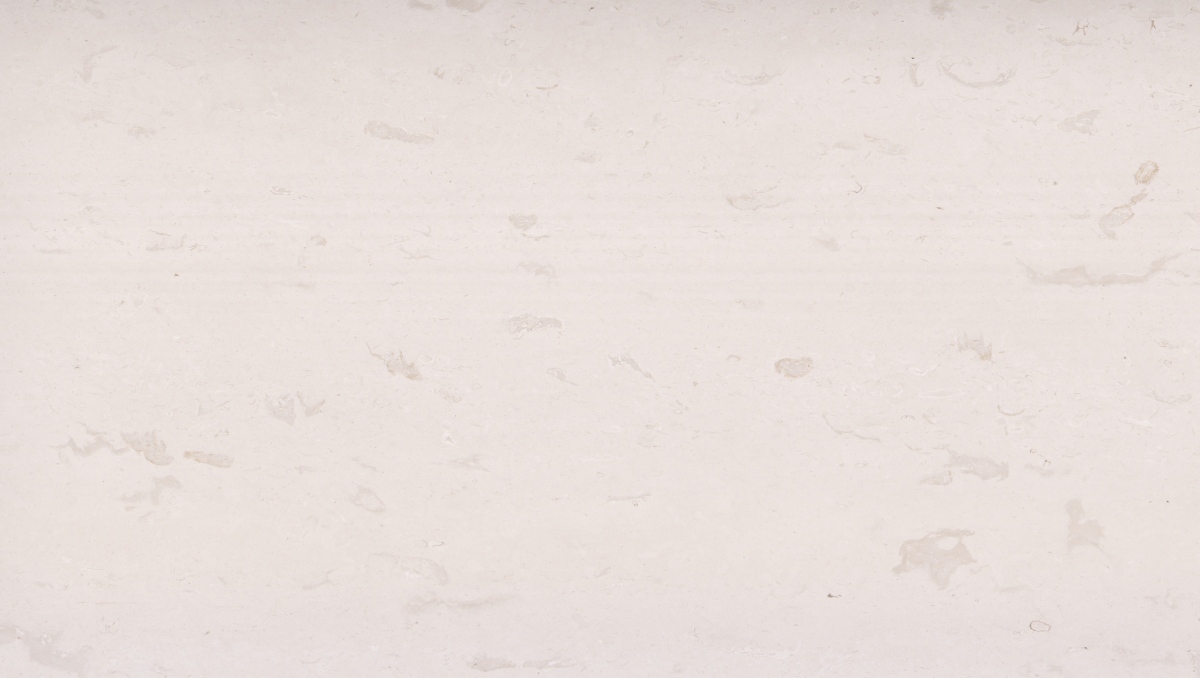 Close-up of warm white limestone surface with faint beige-grey markings 